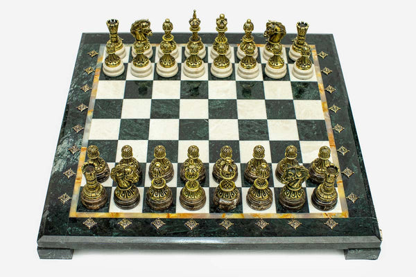 Green and cream marble chess set with hand-cast bronze pieces arranged for play and brass coordinate medallions