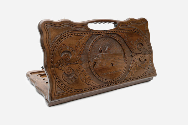 Carved beechwood backgammon board with St. Mary Church in a central medallion and a carry handle, propped open