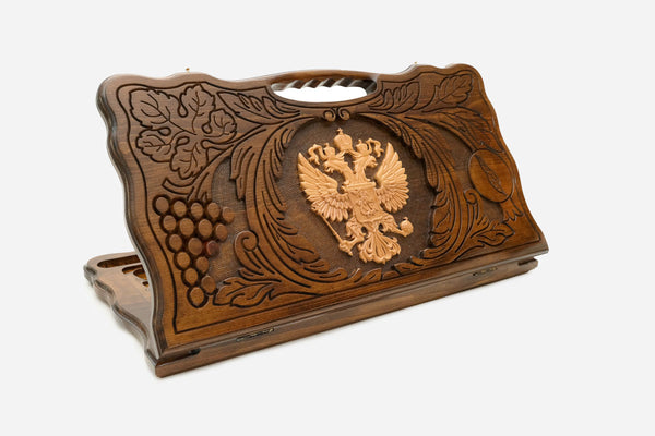 Carved beechwood backgammon board with the Russian double-headed eagle coat of arms and a carry handle, shown propped open