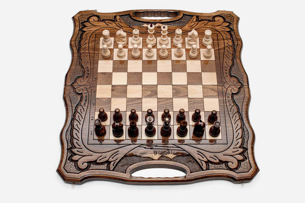 Folding walnut chess board with carved scrollwork borders, a Mount Ararat inlay and beech and walnut pieces in starting position