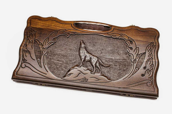 Carved beechwood backgammon board with a wolf medallion and a carry handle, propped open