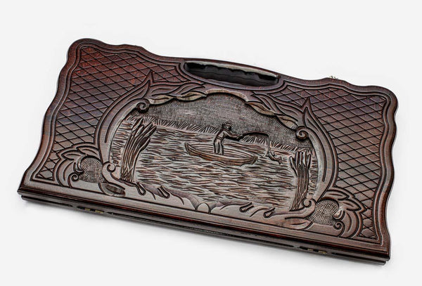 Carved beechwood backgammon board with a fisherman in a medallion, propped open
