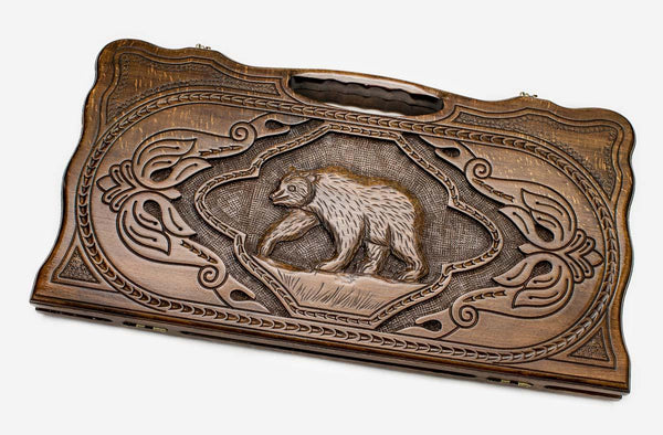 Carved beechwood backgammon board with a bear medallion and a carry handle, propped open