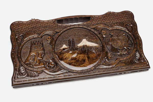 Carved beechwood backgammon board with Mount Ararat in a central medallion and two side scenes, propped open