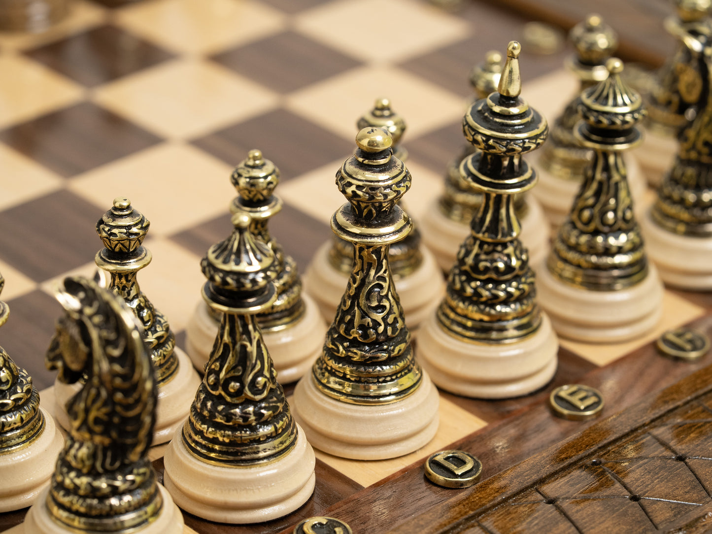 Luxury handcrafted chess set with storage and a full set of bronze metal chess pieces displayed.