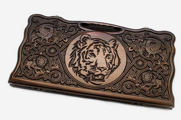 Carved beechwood backgammon board with a tiger medallion and a carry handle, propped open