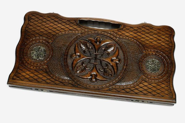 Carved beechwood backgammon board with a central medallion and bronze roundels, propped open