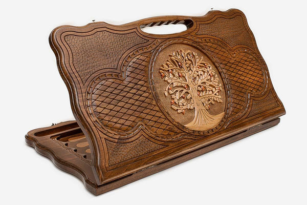 Carved beechwood backgammon board with a tree of life medallion and a carry handle, propped open