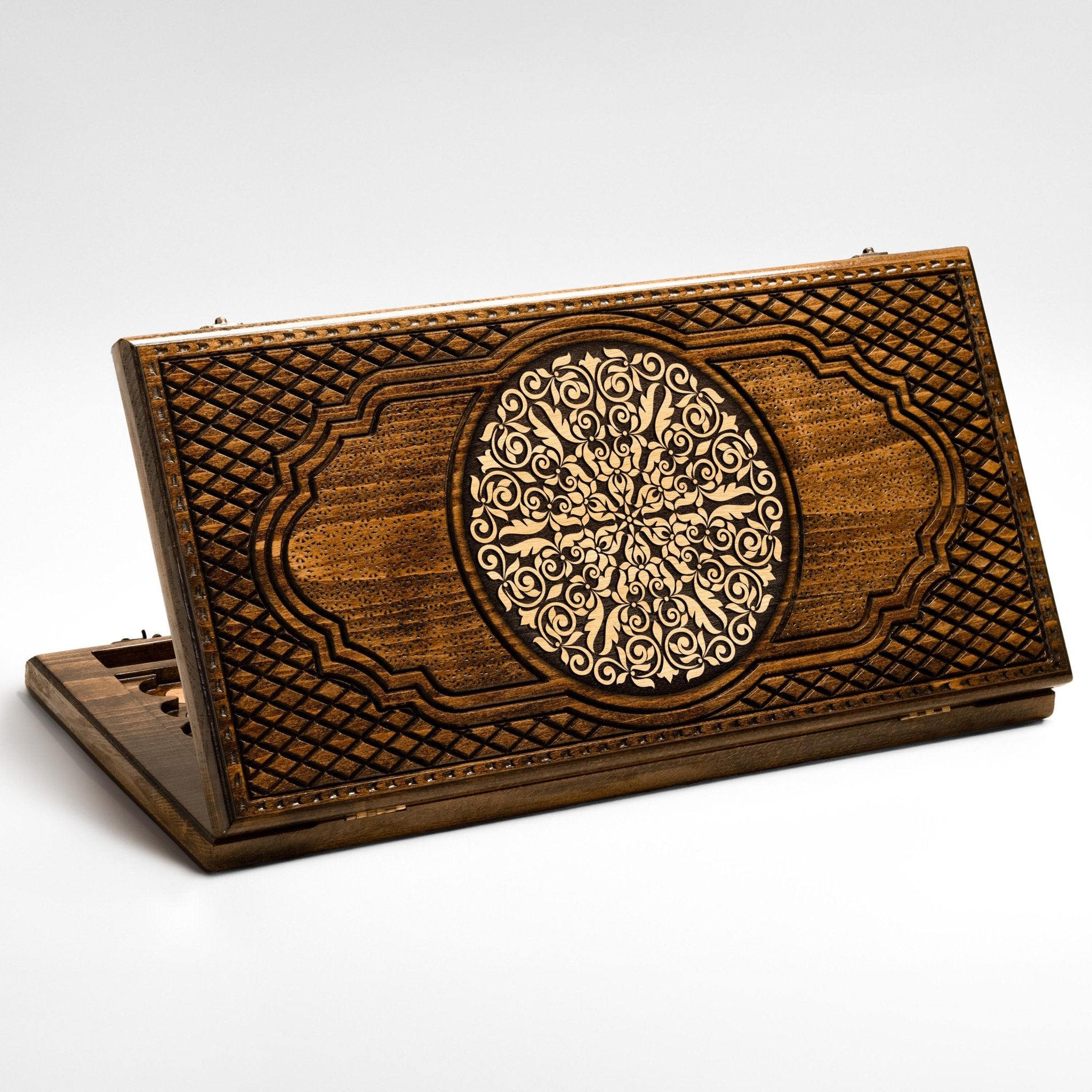 A hand-carved wooden backgammon board set up for a game on a family table.