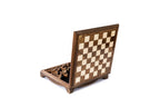 Close-up of wooden chess pieces on detailed chess board