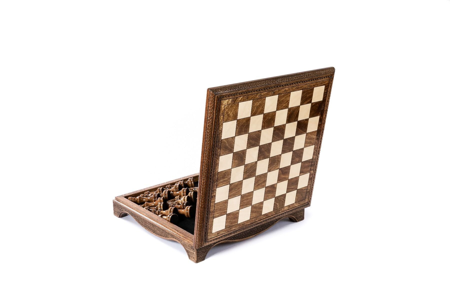 Close-up of wooden chess pieces on detailed chess board