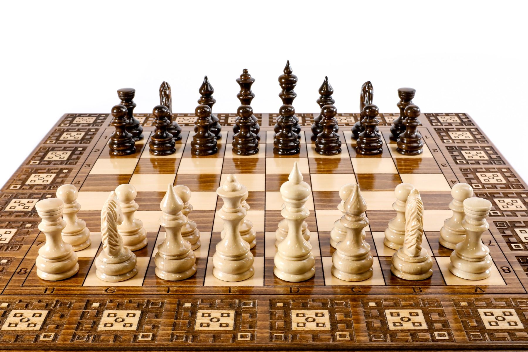 Close-up of the detailed carpet motif carvings and solid wood finish on this 2-in-1 classic board.