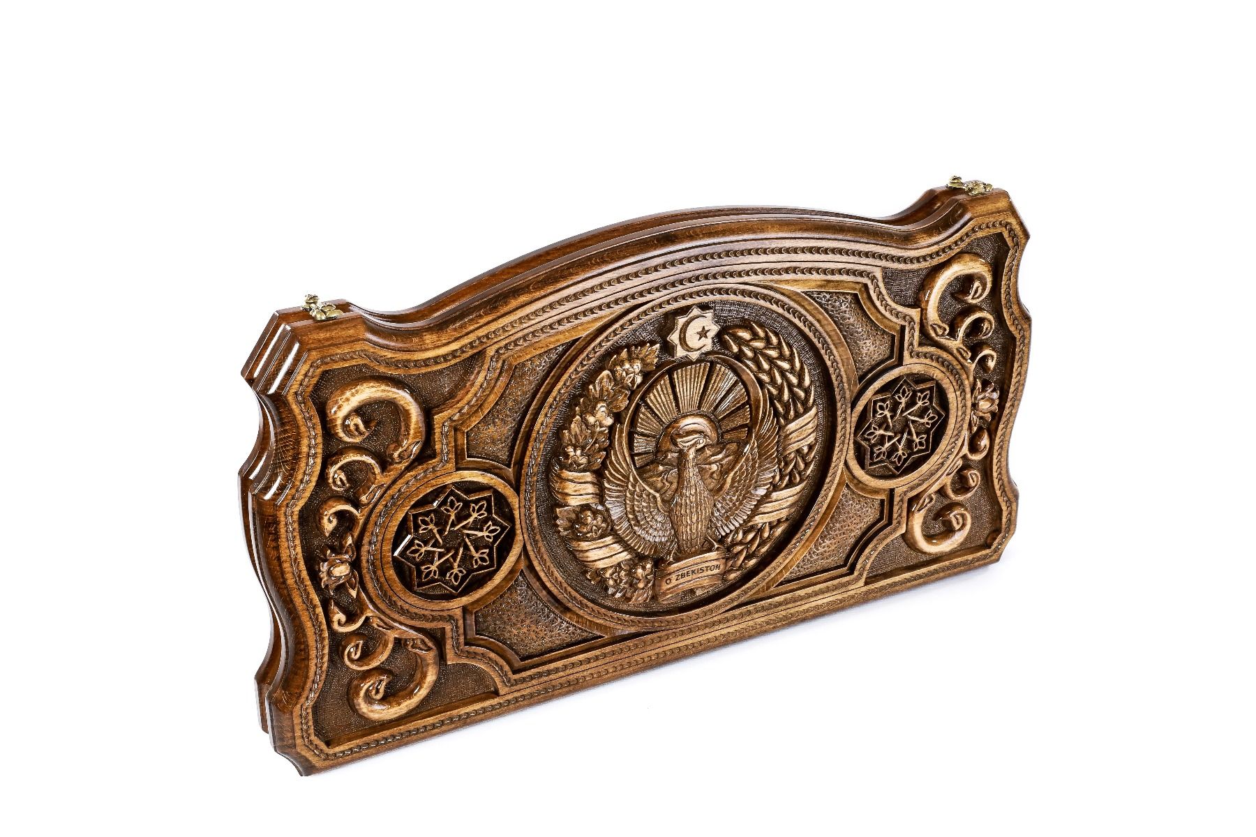 A close-up of the hand-carved Humo bird and sun details, showcasing the extreme precision and depth of the solid wood craftsmanship.