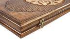 Edge of the closed backgammon board with the cast-bronze clasp and the lattice lid