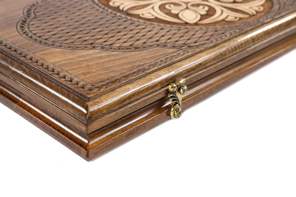 Edge of the closed backgammon board with the cast-bronze clasp and the lattice lid