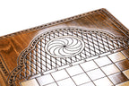 Eternity whirl carved in the lattice cartouche beside the chequerboard on the back cover