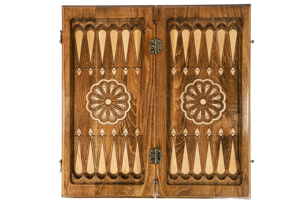 Open medium backgammon board from above: dark field, pale points, wheel ornament on each half