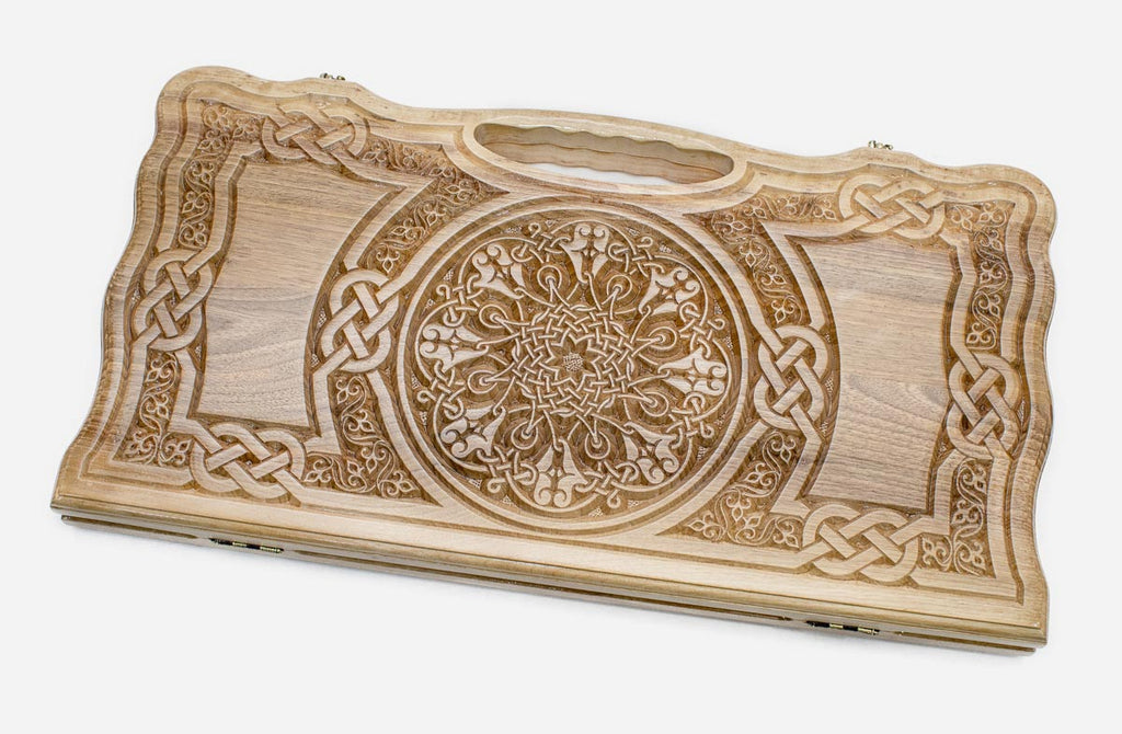 Carved walnut backgammon board with intricate Celtic knotwork and a rosette, shown flat