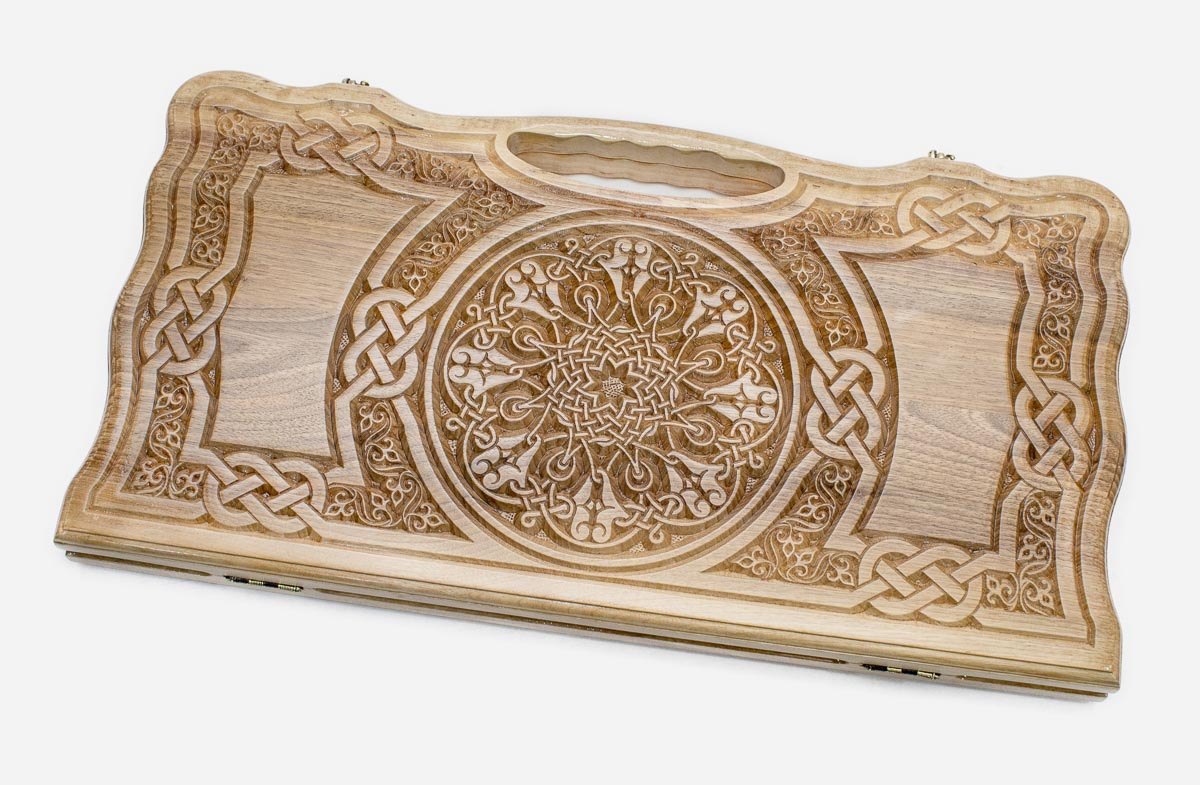 Carved walnut backgammon board with intricate Celtic knotwork and a rosette, shown flat