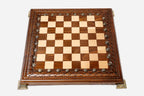 Carved chess set shown folded with carry handle