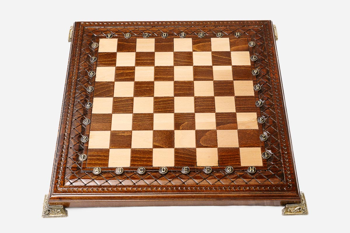 Carved chess set shown folded with carry handle