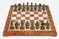 Coral and cream marble chess set with hand-cast bronze pieces arranged for play and brass coordinate medallions