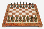 Coral and cream marble chess set with hand-cast bronze pieces arranged for play and brass coordinate medallions