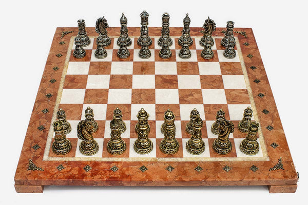 Coral and cream marble chess set with hand-cast bronze pieces arranged for play and brass coordinate medallions