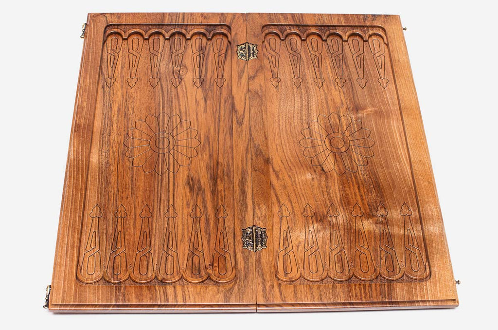 A carved rosette at the corner of the board