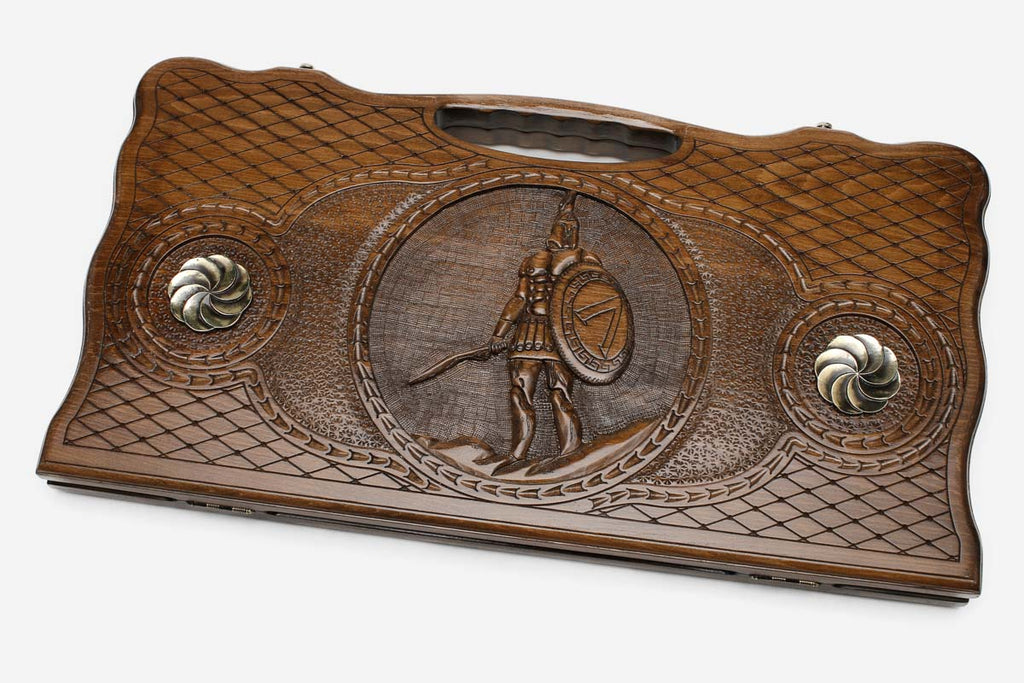 Carved beechwood backgammon board with a Spartan warrior and bronze rosettes, with a carry handle, propped open