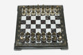 Burgundy and white marble chess set with hand-cast bronze pieces arranged for play and brass coordinate medallions