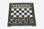 Burgundy and white marble chess set with hand-cast bronze pieces arranged for play and brass coordinate medallions