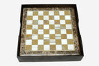 Golden and white marble chess board with hand-cast bronze pieces