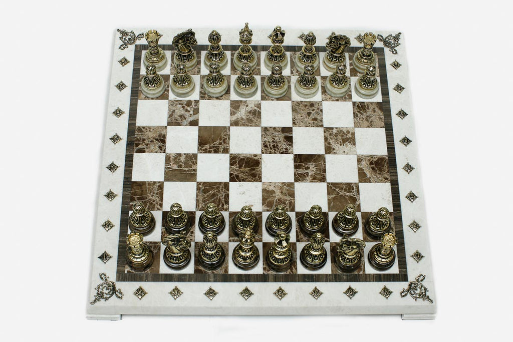 Cream and brown marble chess set with hand-cast bronze pieces arranged for play and brass coordinate medallions