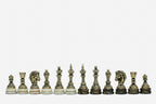 Row of the two-tone bronze chess pieces on marble bases, showing kings, queens, bishops and horse-head knights