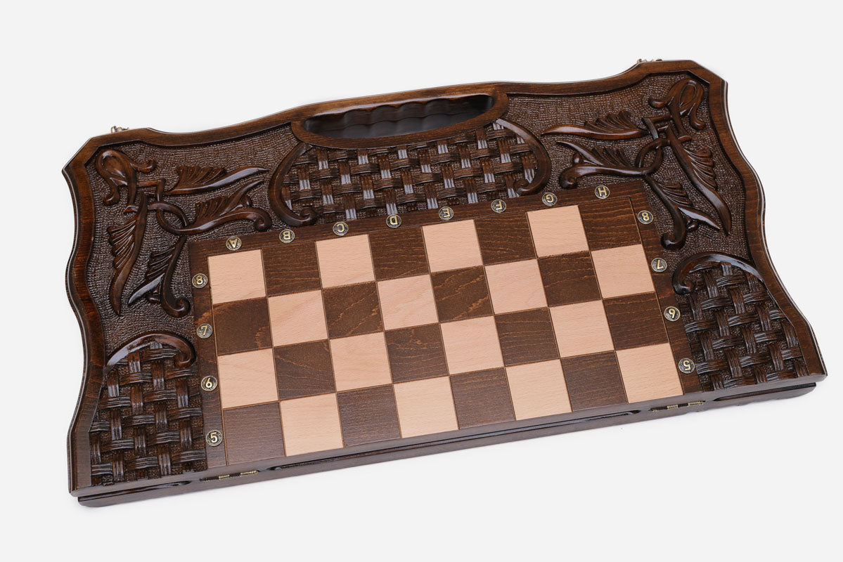Close-up of the basket-weave panels and carved lily scrollwork on the border
