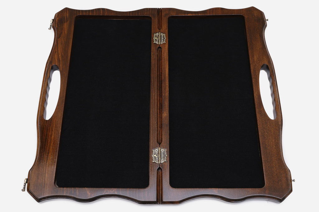 The opened board showing its felt-lined interior compartments and metal clasps