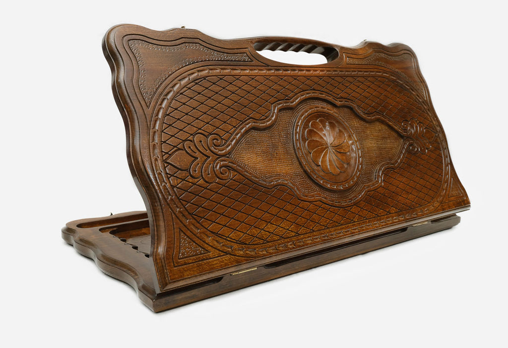 Carved beechwood backgammon board with a rosette medallion and a carry handle, propped open