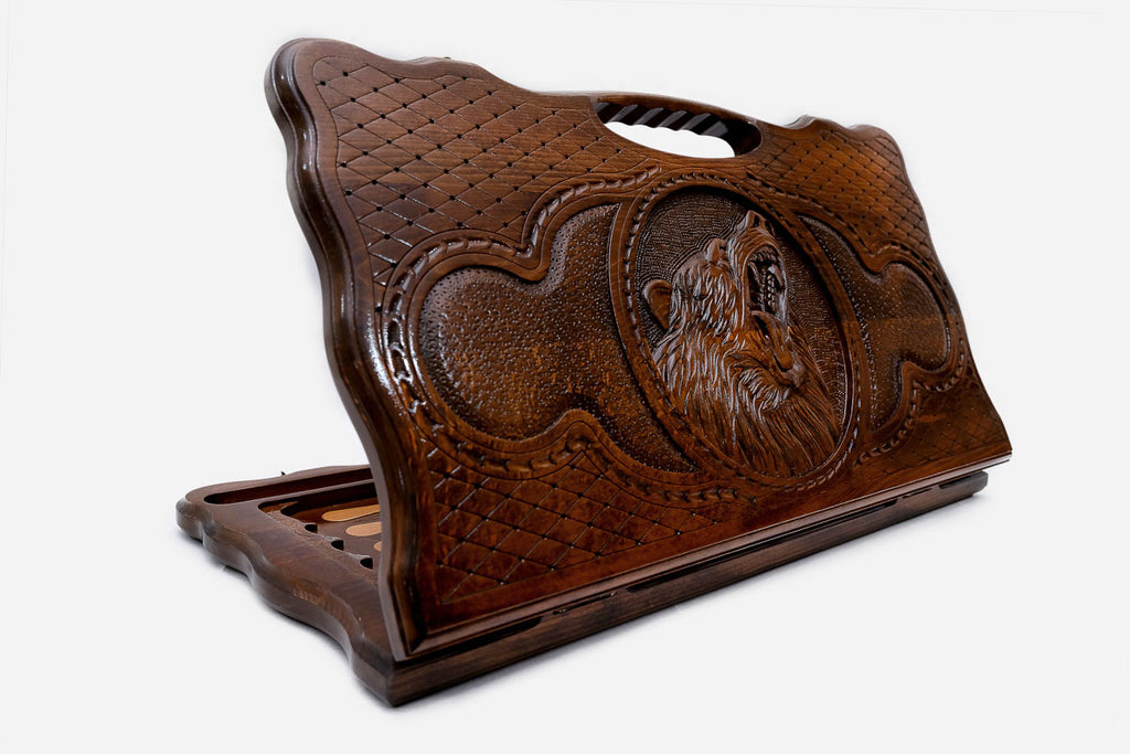 Carved beechwood backgammon board with a bear medallion and a carry handle, propped open