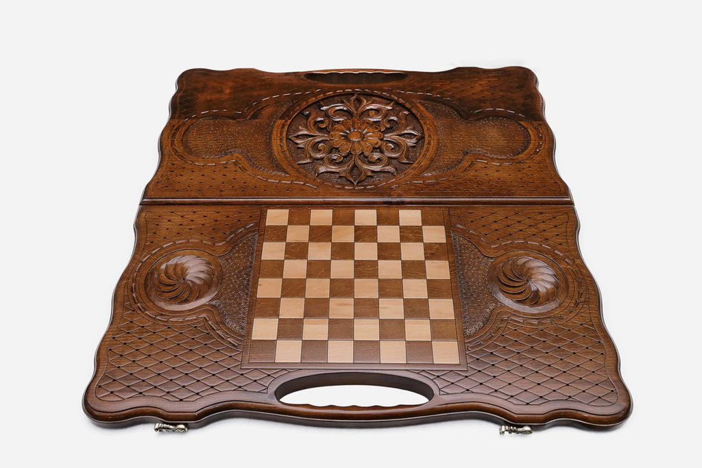 Angled view of the floral medallion carved backgammon board