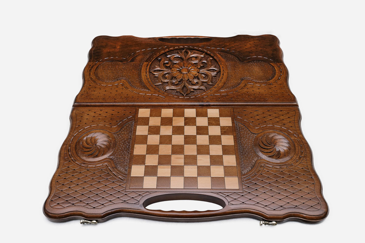 Angled view of the floral medallion carved backgammon board