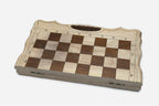 Top-down view of the opened folding board with maple and walnut squares and carry-handle cutout