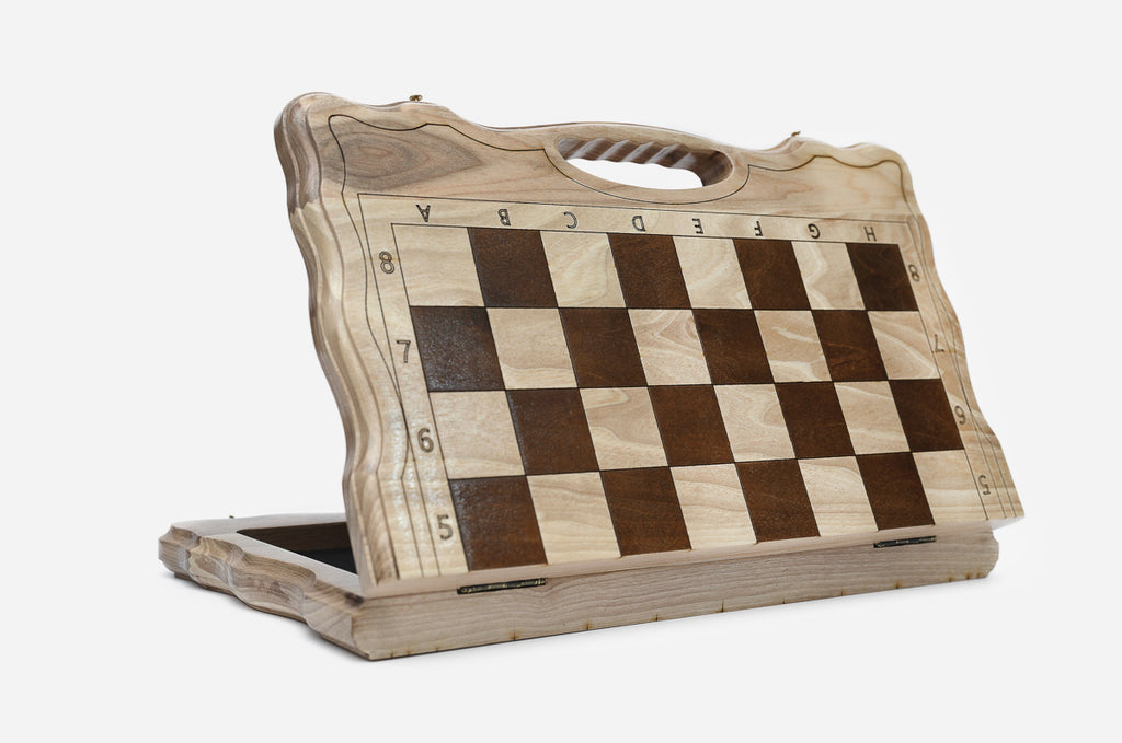 Angled view of the folding chess set with its gold and black metal pieces