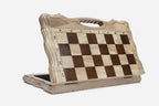 Angled view of the folding chess set with its gold and black metal pieces