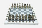Angled view of the grey marble chess board with detailed bronze pieces set up for play