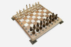 Close-up of an ornate brass corner bracket on the board
