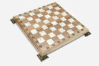 Angled view of the white epoxy chess set with its wooden pieces