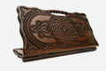 Carved beechwood backgammon board with two knotwork medallions and a carry handle, propped open