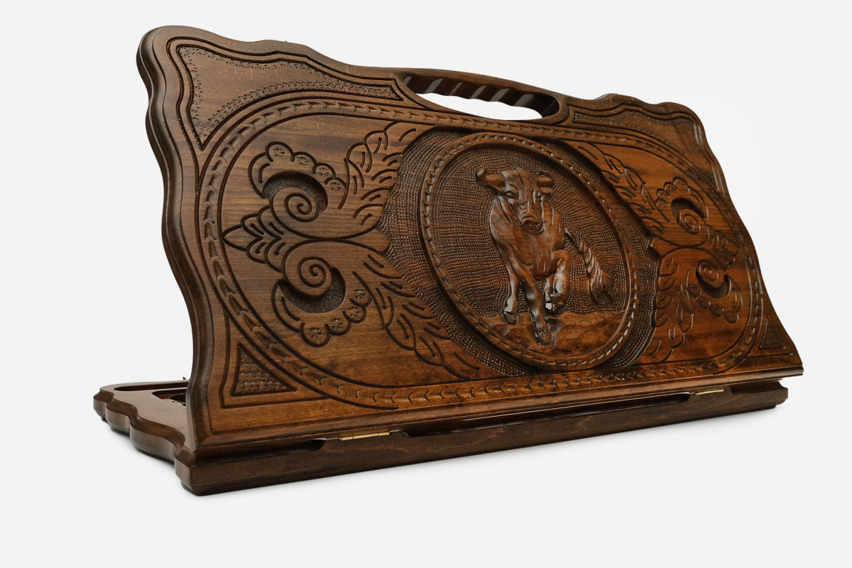 Carved beechwood backgammon board with an ox medallion and a carry handle, propped open
