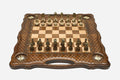 Carved chess board with four brass star inlays, lattice borders and ornate bronze-and-cream figural pieces set up for play